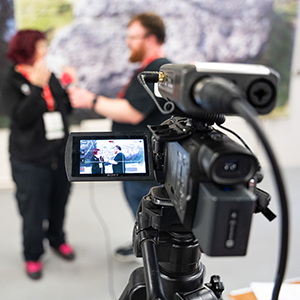 Close-up of a camera recording an interview taking place at an EAA conference
